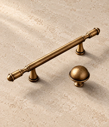 Antique Brass Ringed Cabinet Pulls, Dome Knob & Pendant on warm ivory limestone