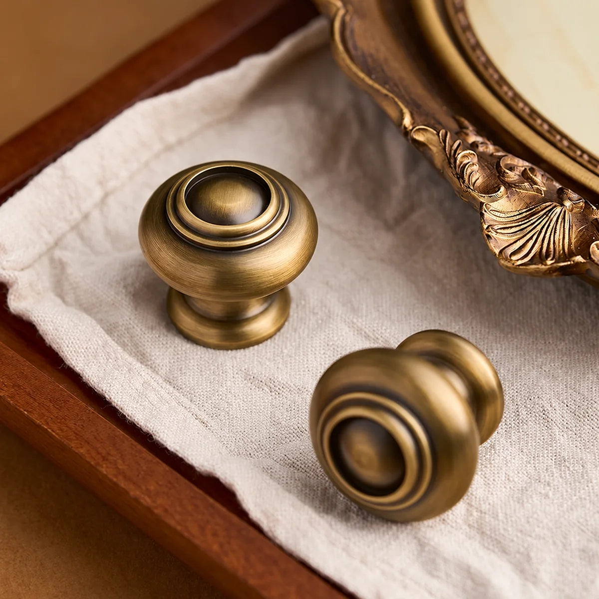 Raised concentric rings and domed center of antique brass cabinet knobs