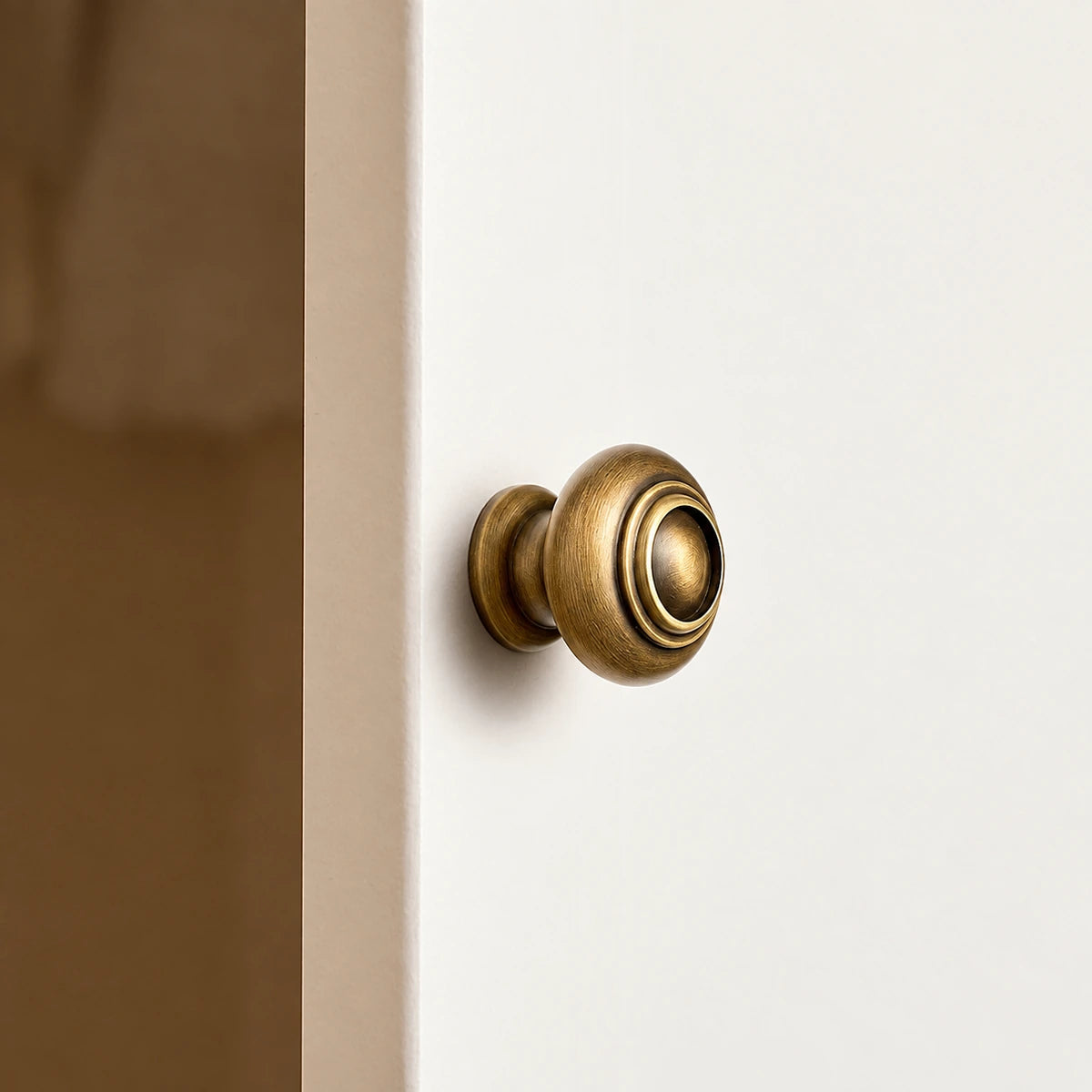 Side view of ringed dome knob mounted on a cabinet door