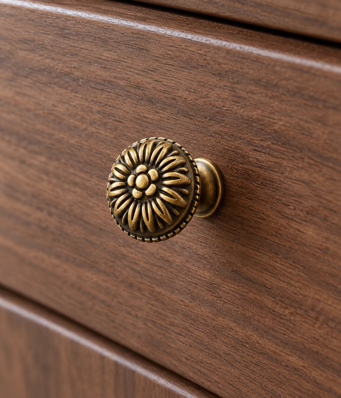 Antique brass rosette cabinet knob fitted to a walnut drawer