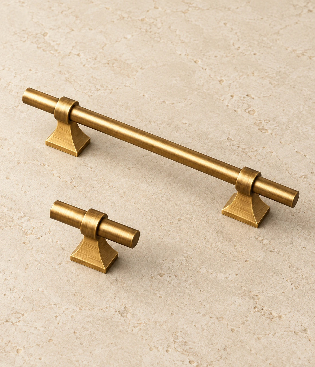 Antique Brass Saddle-Base Cabinet Pulls & T-Knob on warm ivory limestone