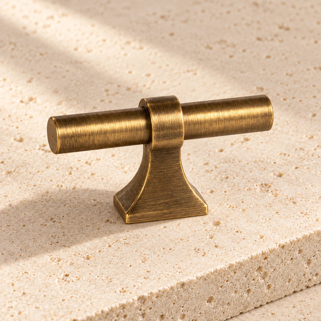 antique brass saddle base t knob limestone on pale limestone.