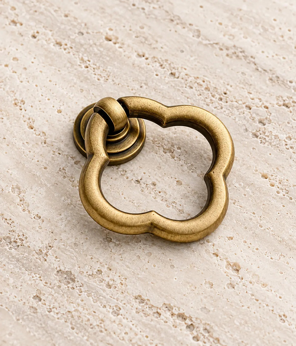 Close view of the scalloped brass ring and stepped circular mounting plate