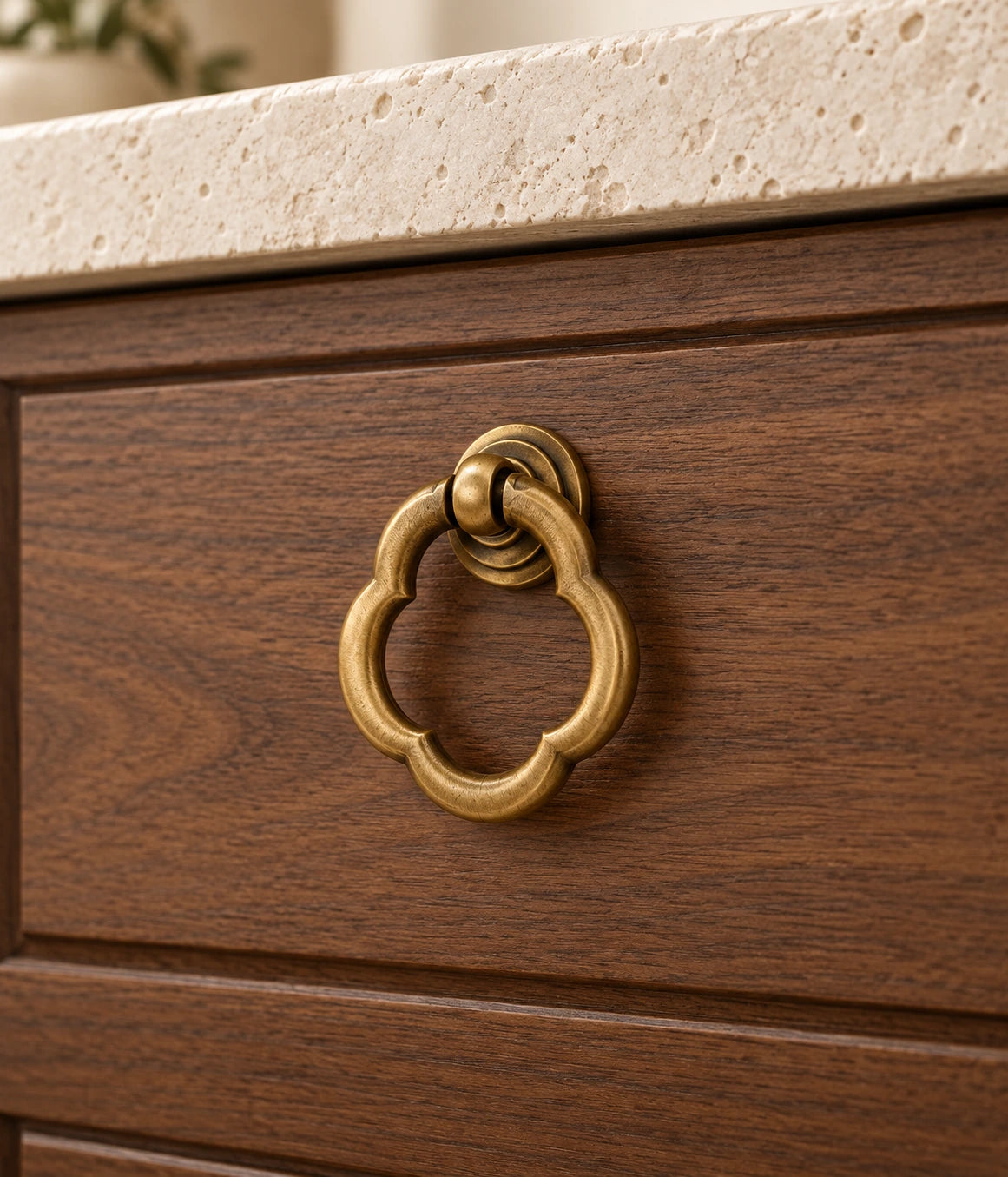Antique Brass Scalloped Ring Cabinet Pull installed on a walnut cabinet drawer