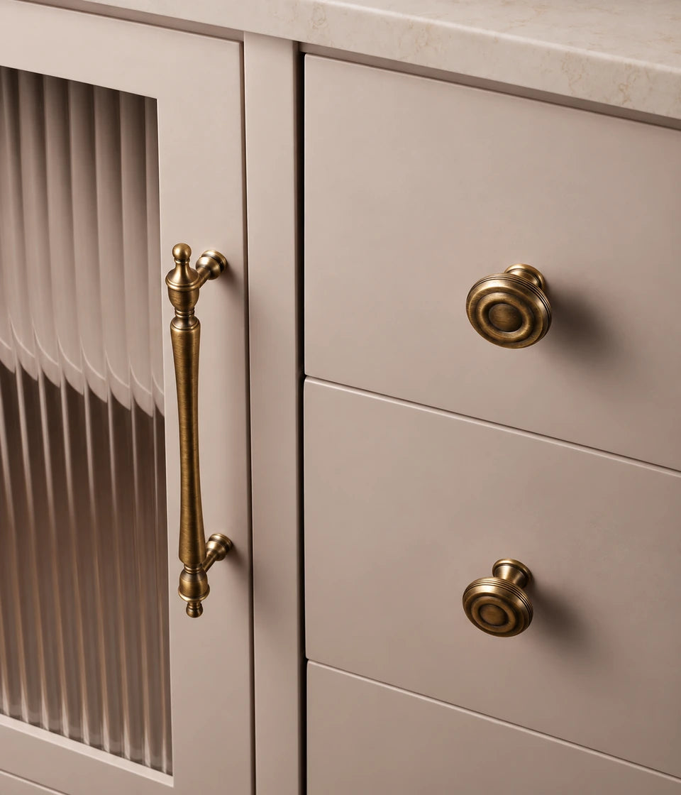 Slender finial cabinet pull and grooved knobs fitted to cabinet doors and drawers