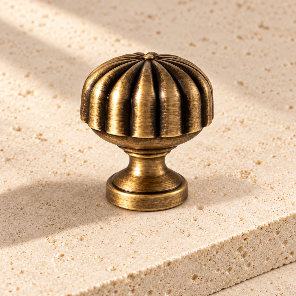 antique brass spiral fluted knob limestone on pale limestone.