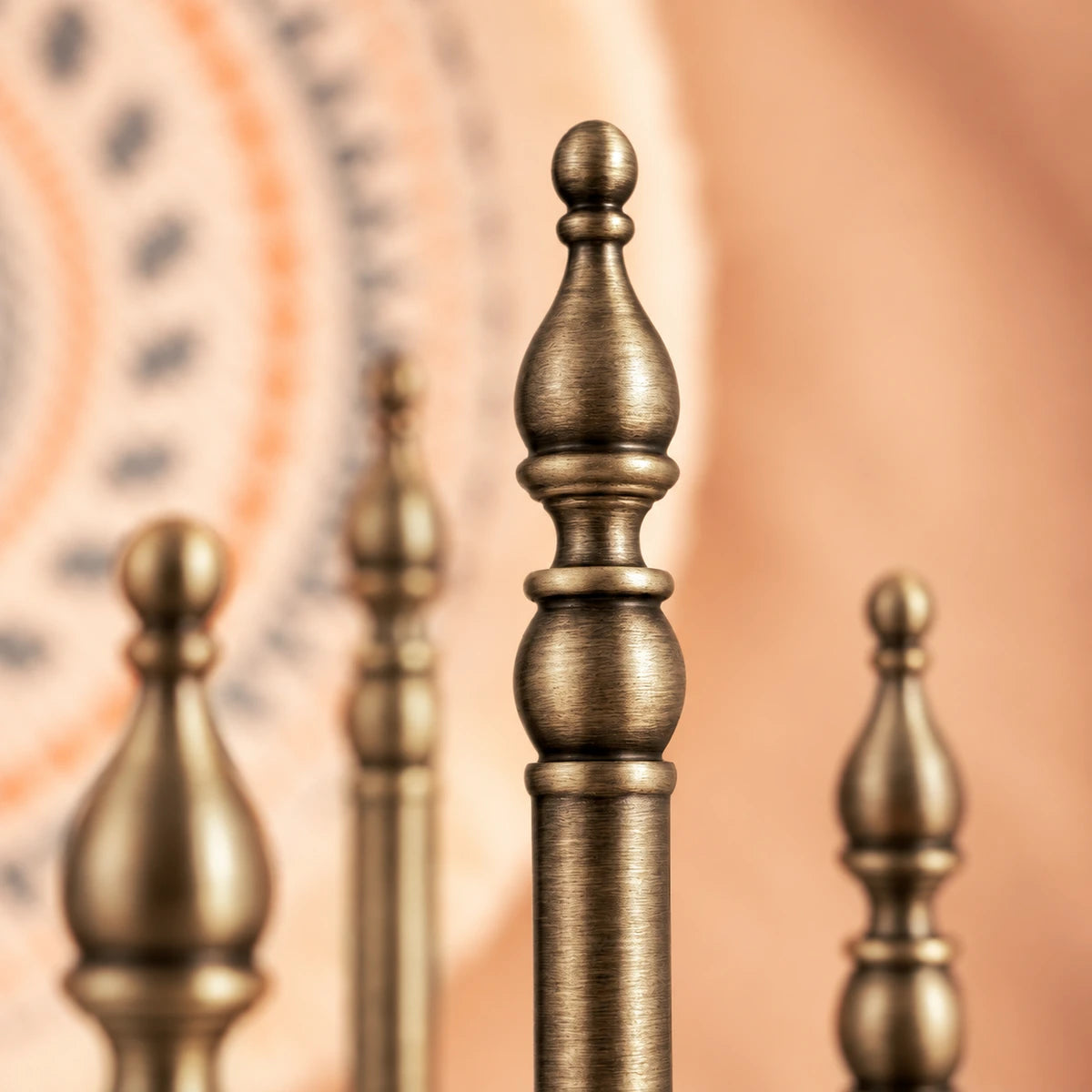 Close-up of shaped brass finial and small ball tip