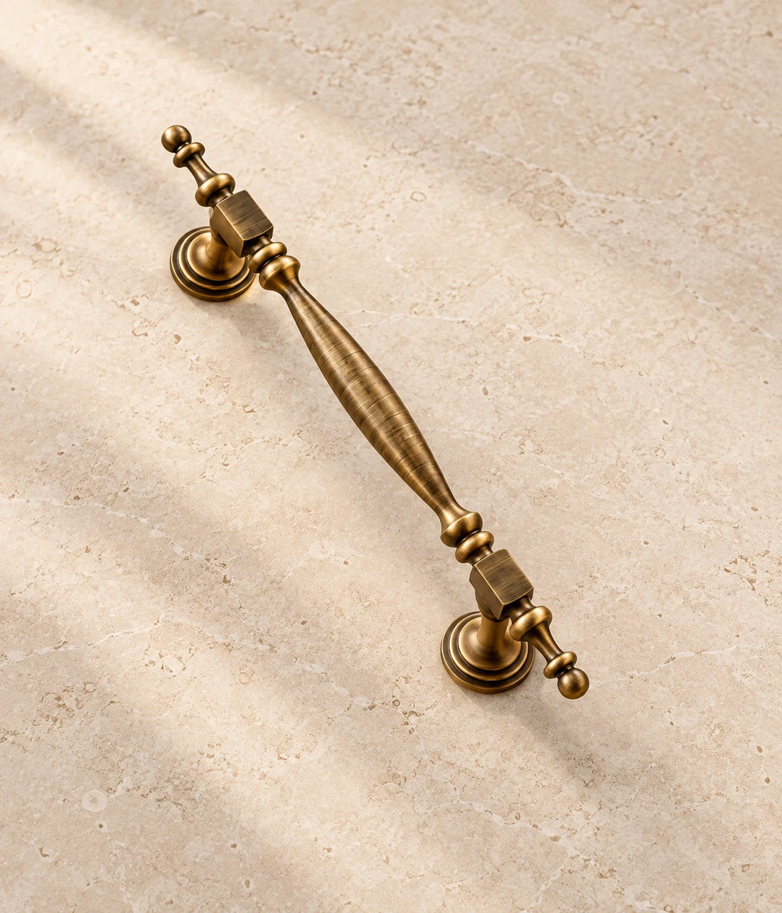 Antique Brass Square-Collar Cabinet Pulls on warm ivory limestone