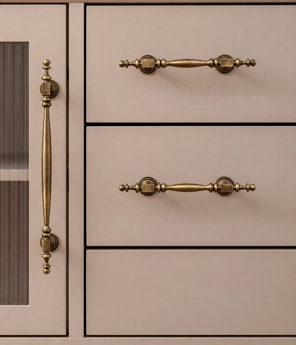 Square-collar brass pulls installed vertically on a cabinet door and horizontally on two drawers
