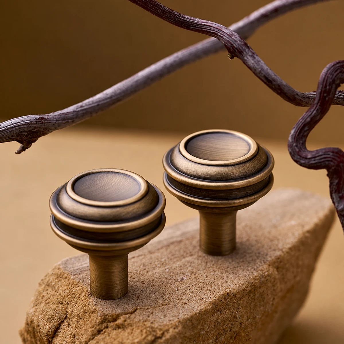 Stepped round antique brass cabinet knobs with concentric ring detail