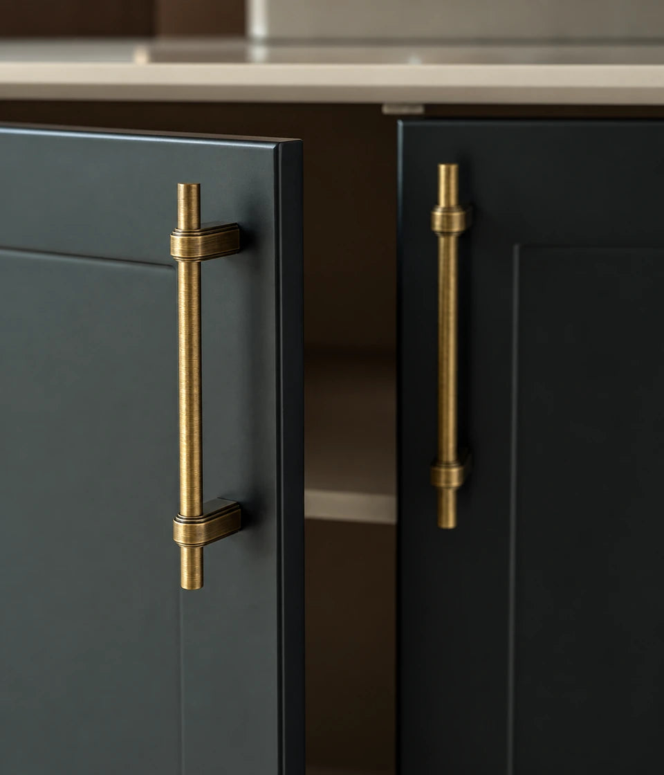 Antique brass strap-post handles mounted vertically on dark cabinet doors