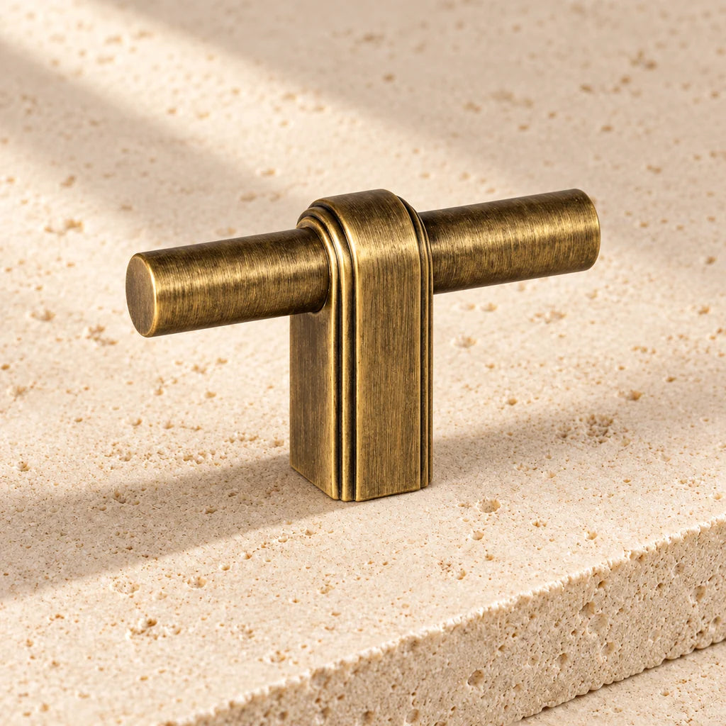antique brass strap post t knob limestone on pale limestone.