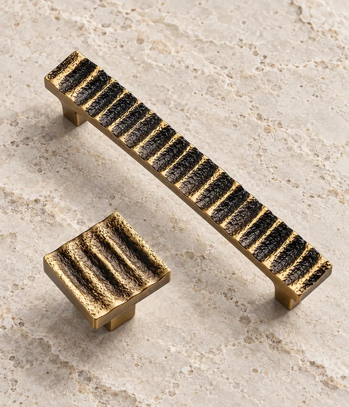 Detail of the dark textured waves and golden ridges on the brass pull and knob