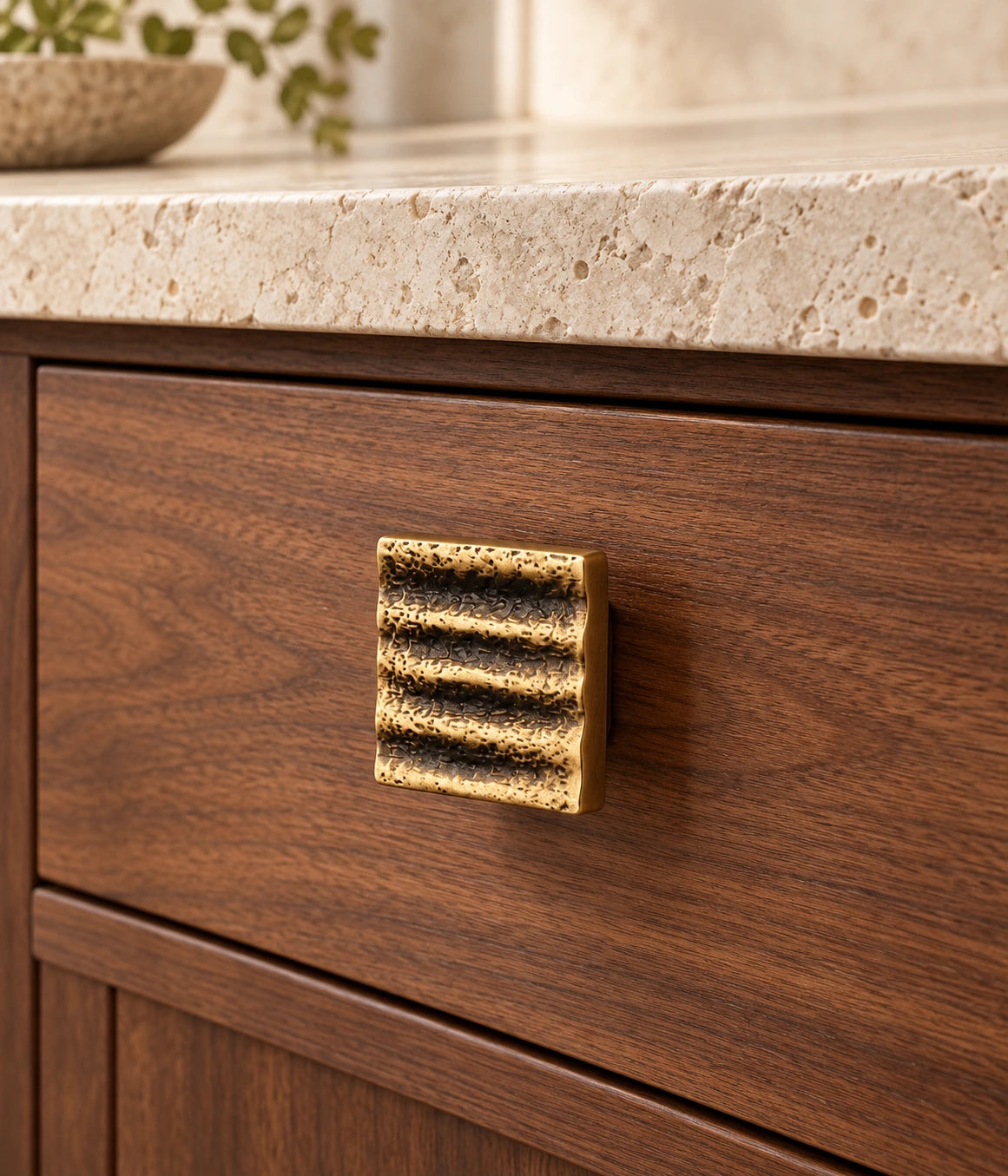 Antique Brass Textured Wave Cabinet Pulls & Square Knob installed on a walnut cabinet drawer