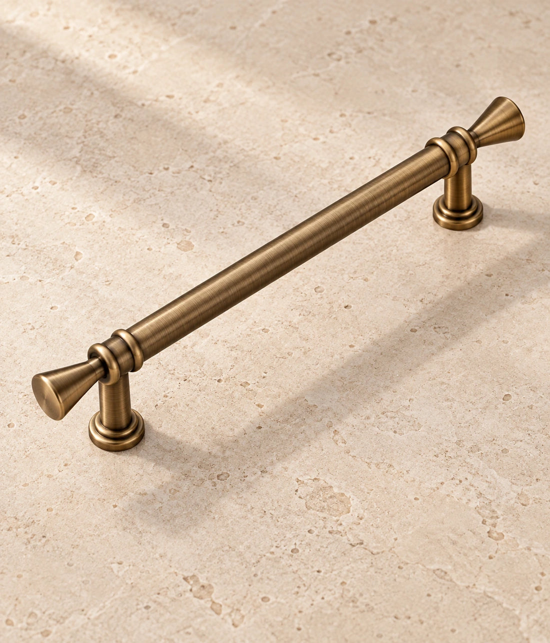 Antique Brass Trumpet Tip Cabinet Pulls & T-Knob on warm limestone