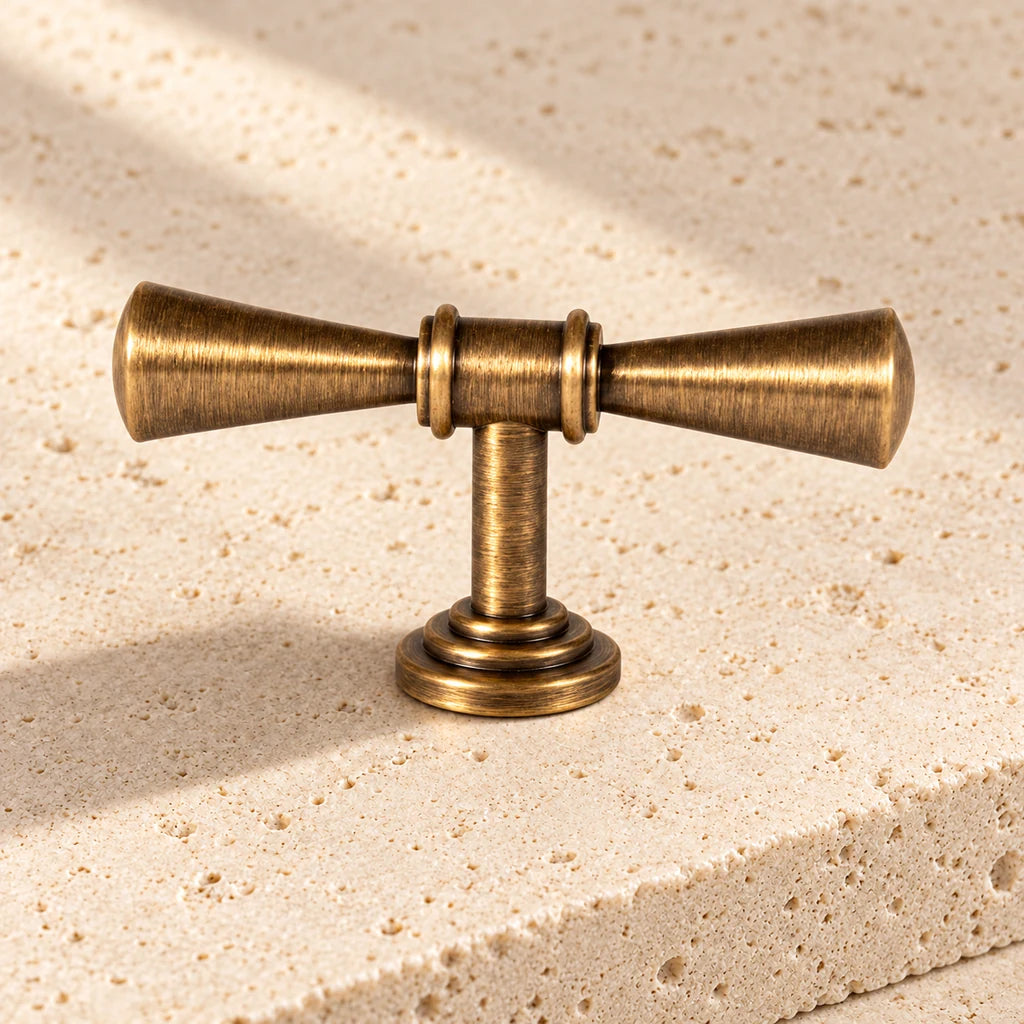 antique brass trumpet tip t knob limestone on pale limestone.