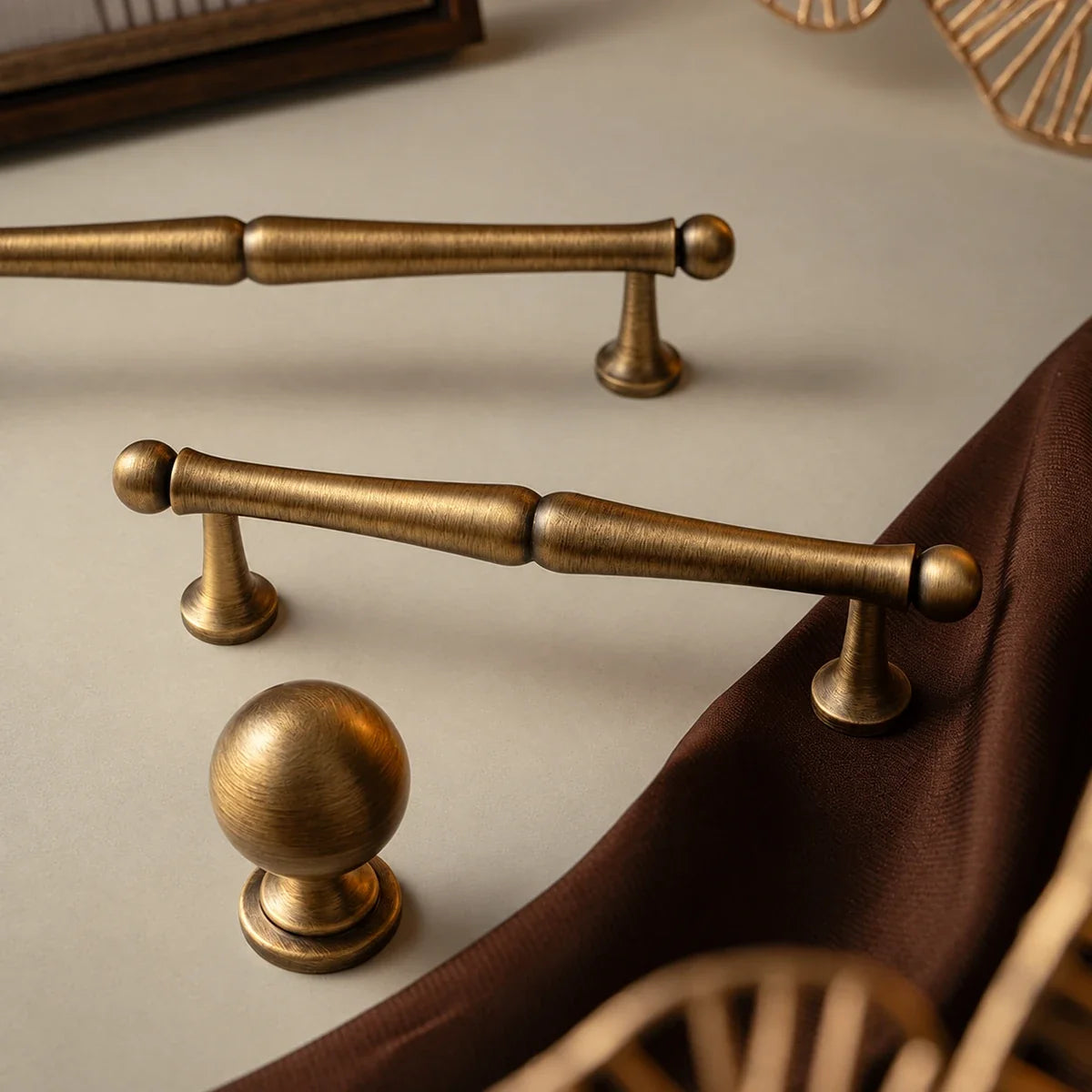 Detail of solid brass turned cabinet pull and matching ball knob