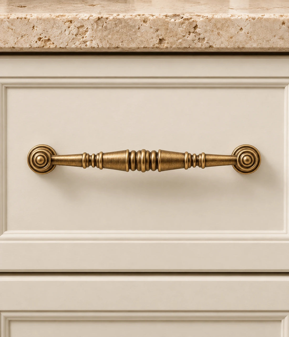 Antique brass turned-spindle cabinet pulls and concentric-ring knob