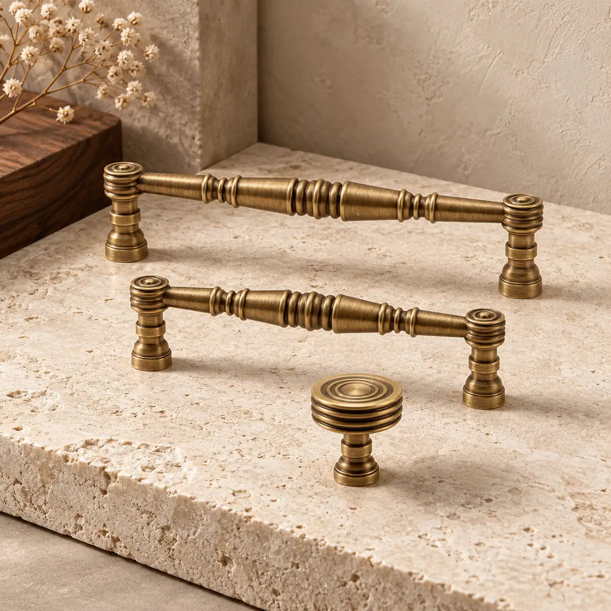 Antique brass turned-spindle cabinet pulls and concentric-ring knob