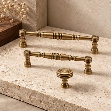 Antique brass turned-spindle cabinet pulls and concentric-ring knob