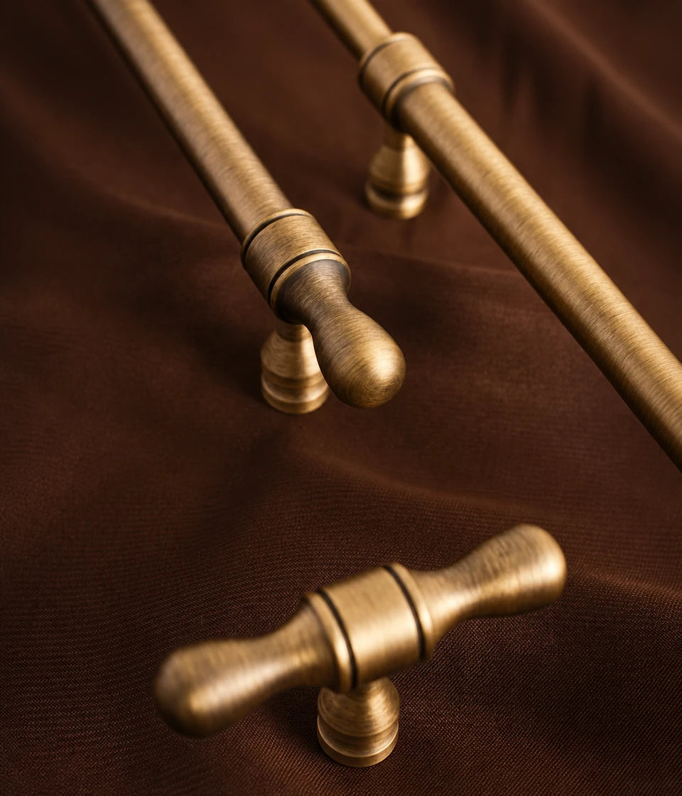 Antique brass turned-tip pull and T-knob detail on brown fabric