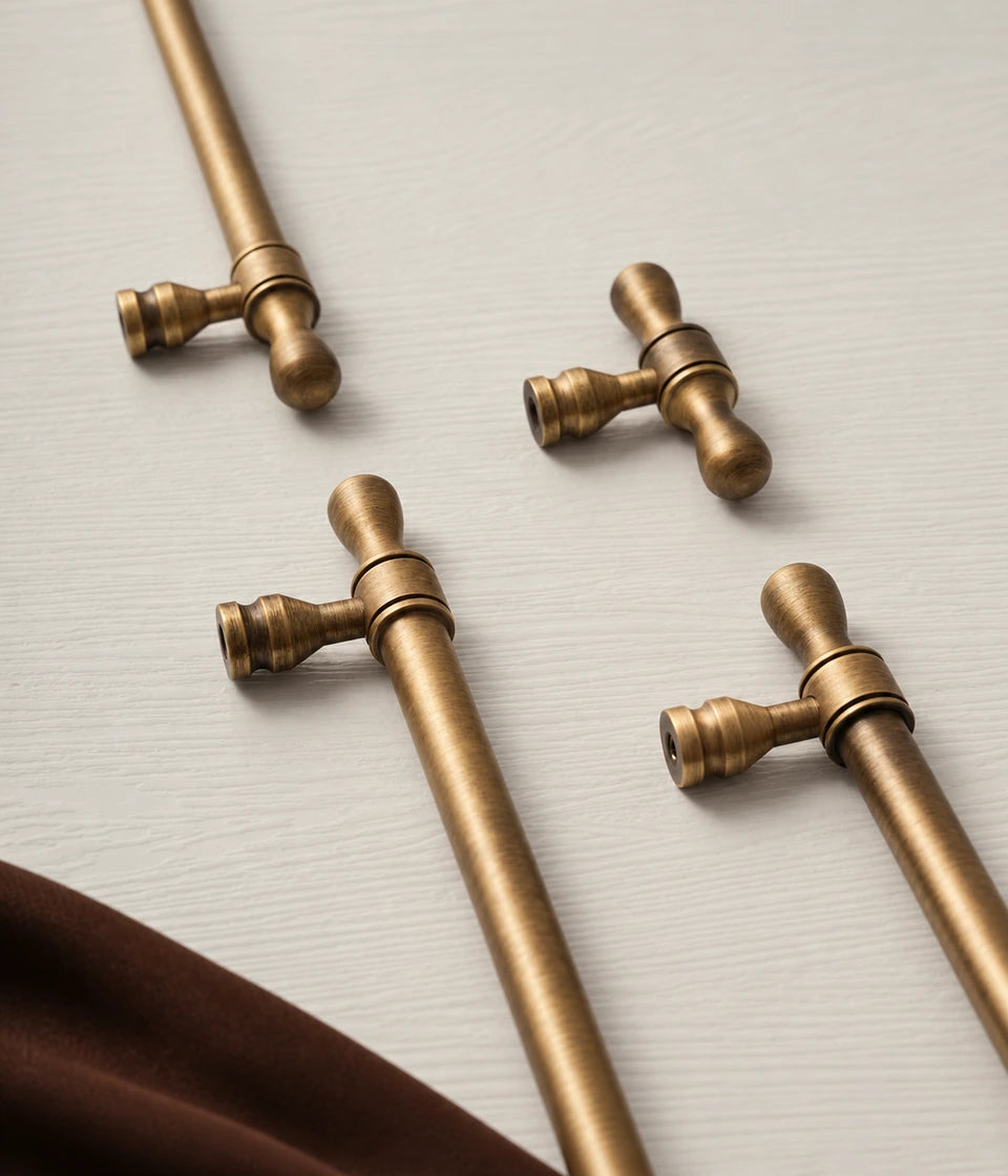 Antique brass turned-tip pulls showing sculpted posts