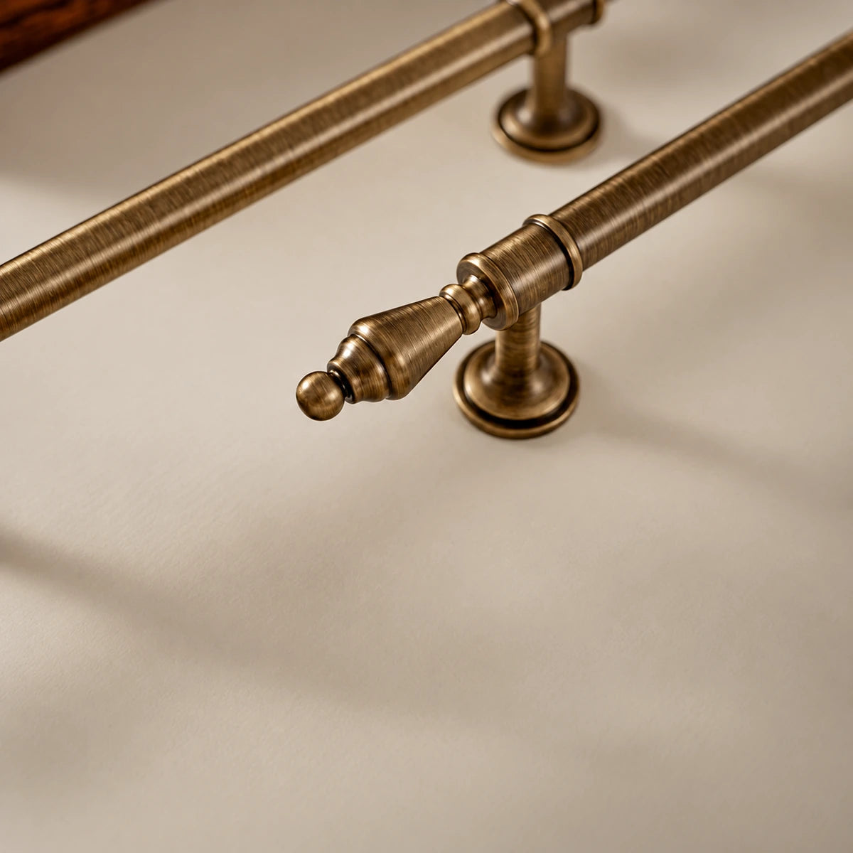 Close-up of urn-shaped brass finial, round tip, collar and mounting base