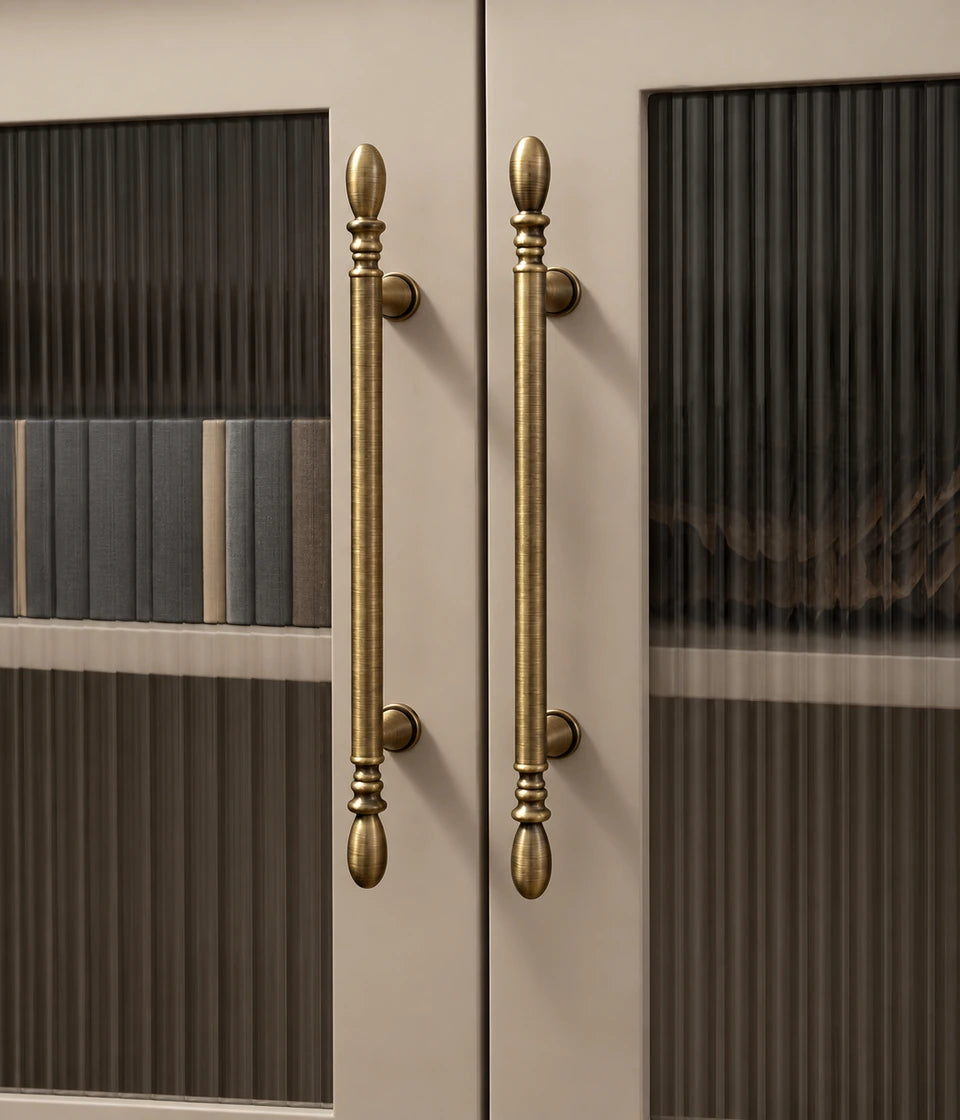 Antique brass water-drop cabinet pulls installed vertically on cabinet doors