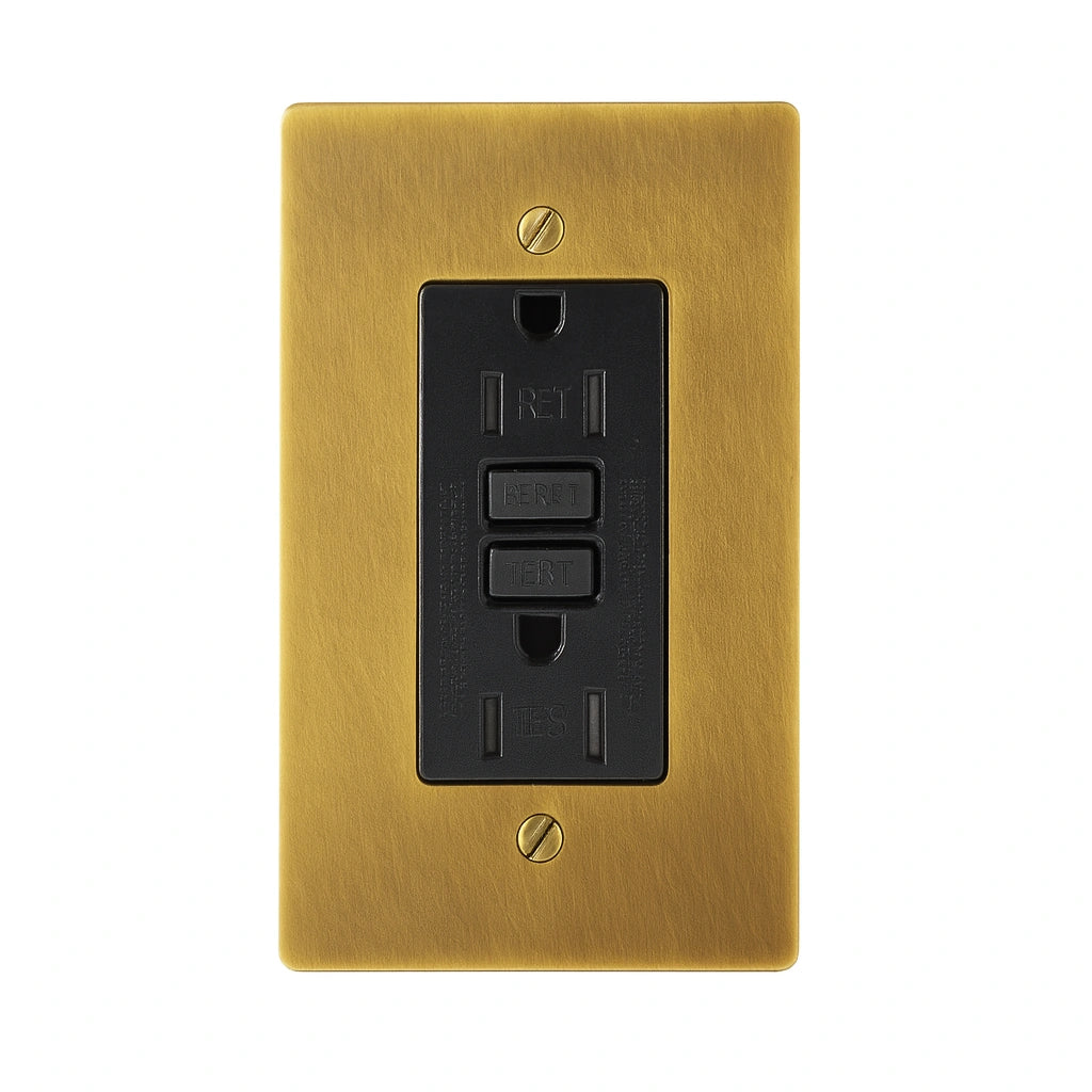 Antique brushed brass wall plate with black GFCI outlet on a white background