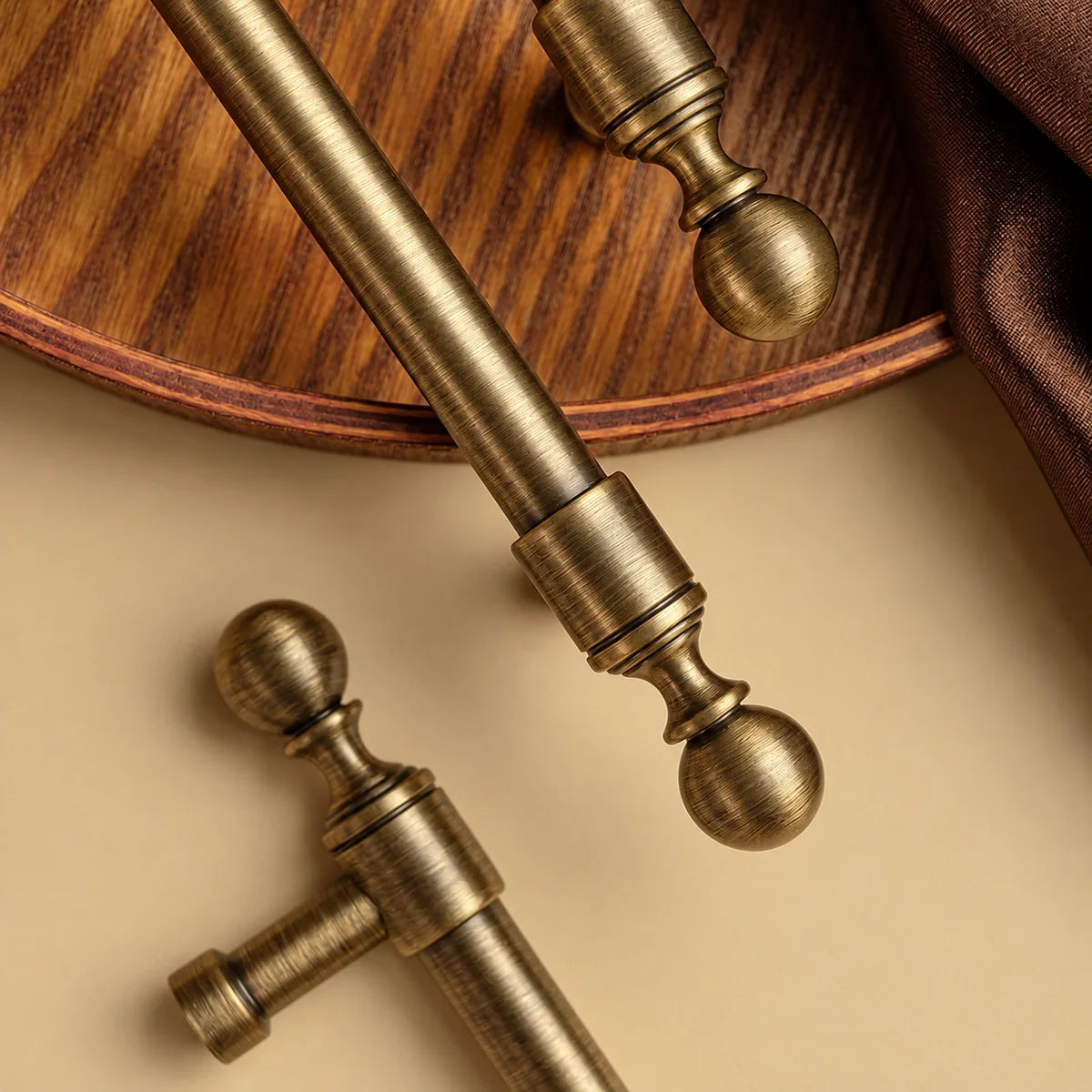 Close-up of cylindrical collars, ball finials and brushed brass finish
