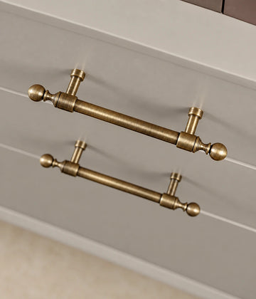 Antique brass collared ball-end pulls installed on cabinet drawers