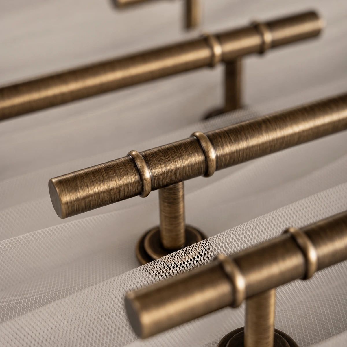 Close-up of raised double collars and the smooth antique brass pull grip
