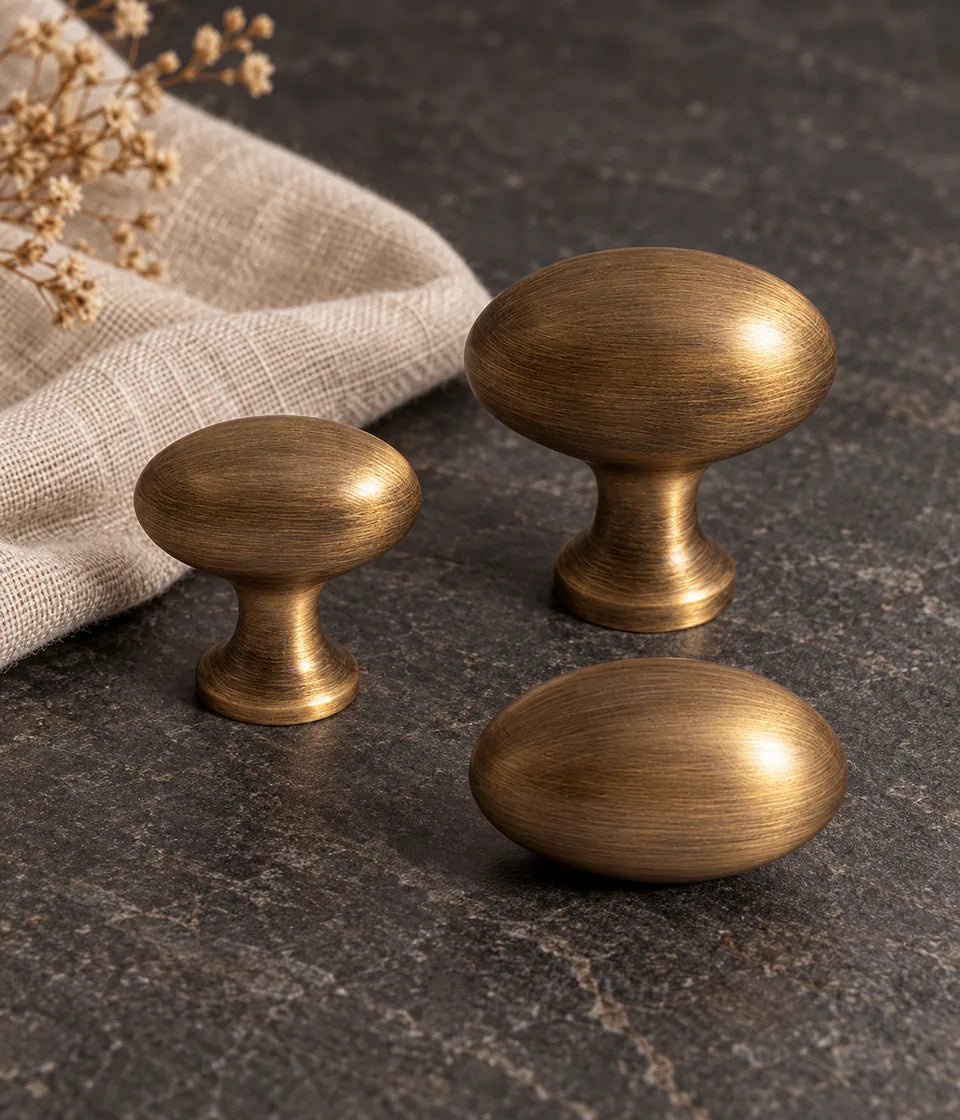 Antique brass egg cabinet knobs in small pedestal, large pedestal and stemless styles