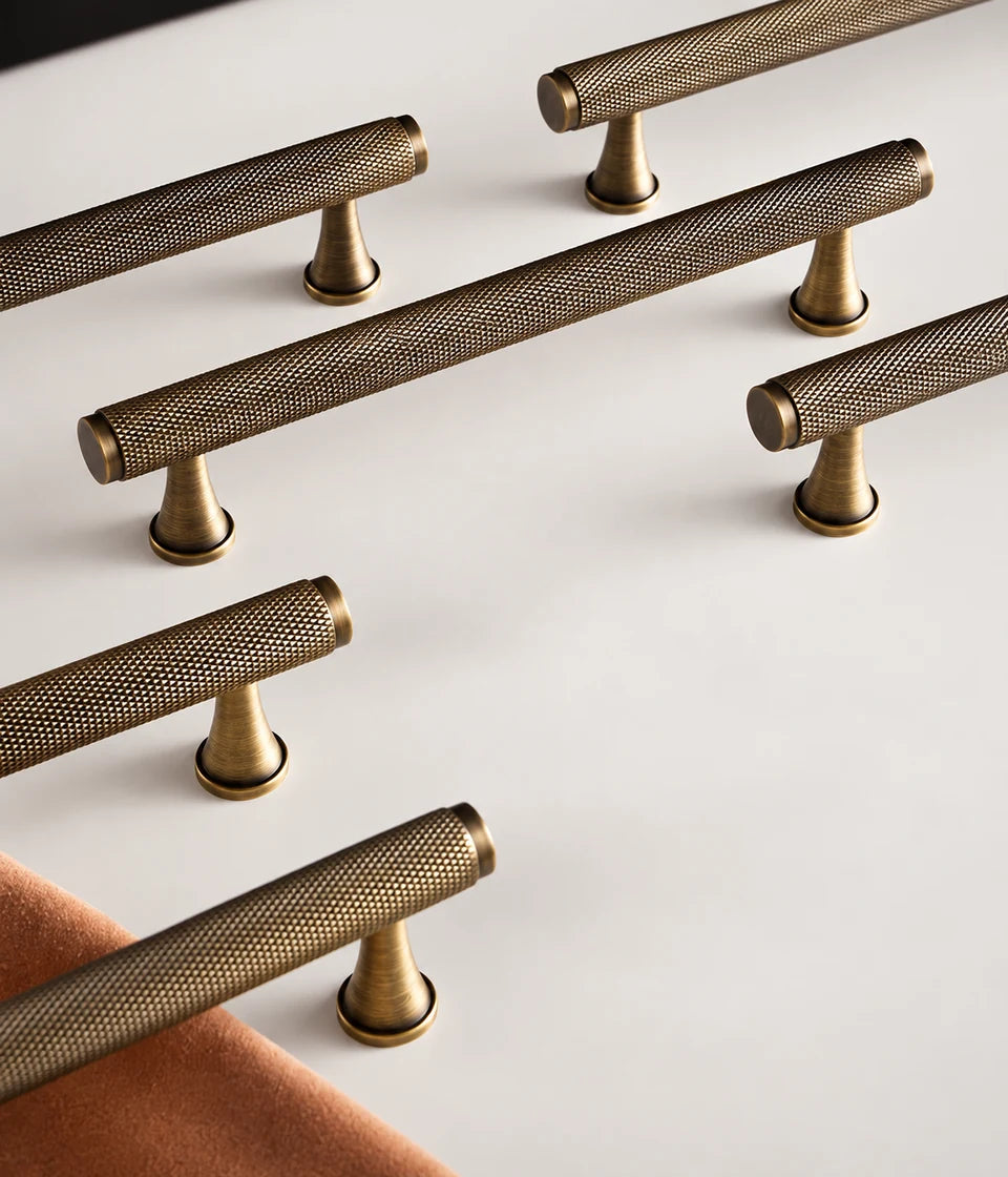 Five full diamond-knurled brass bar pulls with flared mounting posts