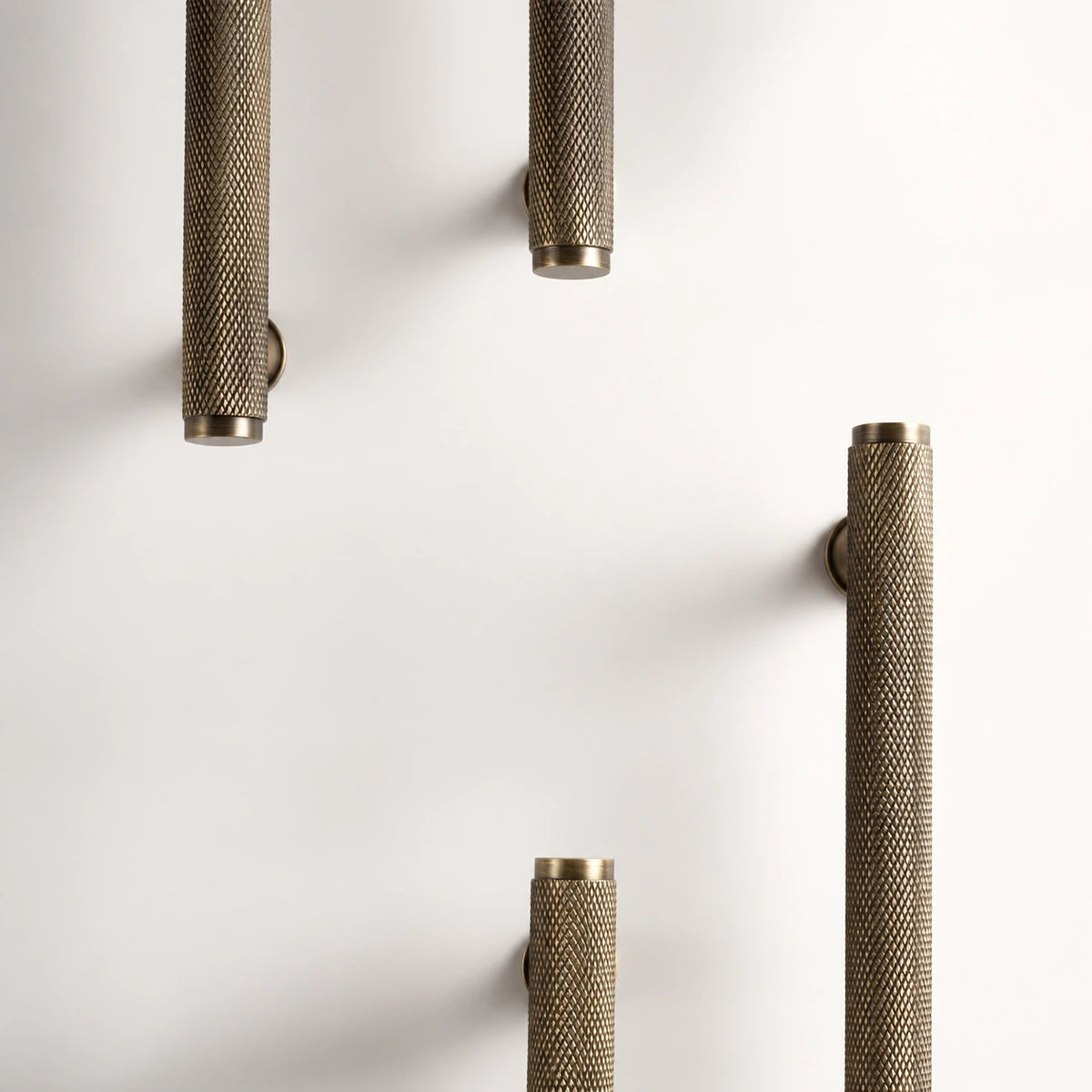 Antique brass full knurled bar pulls arranged overhead