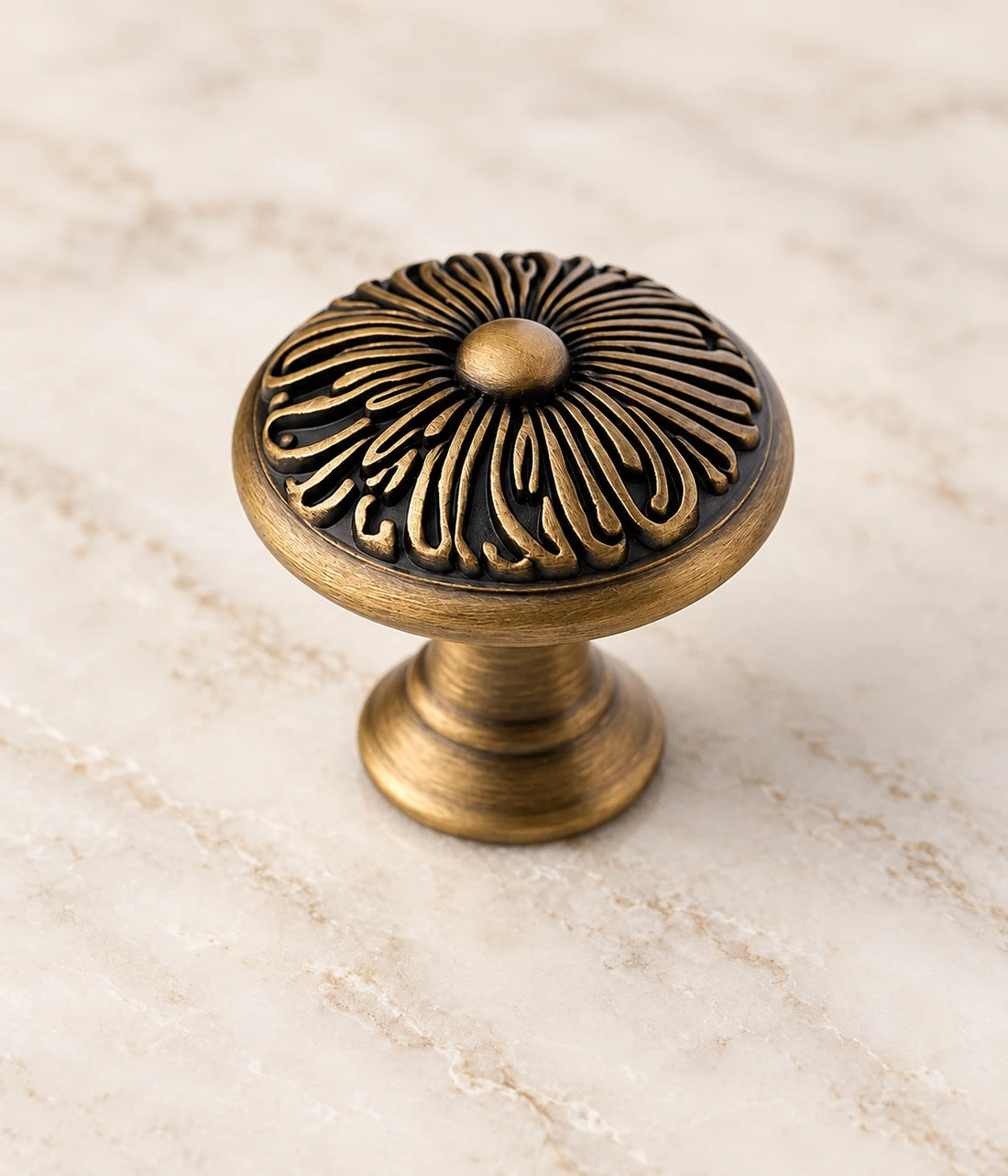 Antique brass chrysanthemum cabinet knobs arranged on pale stone ledges