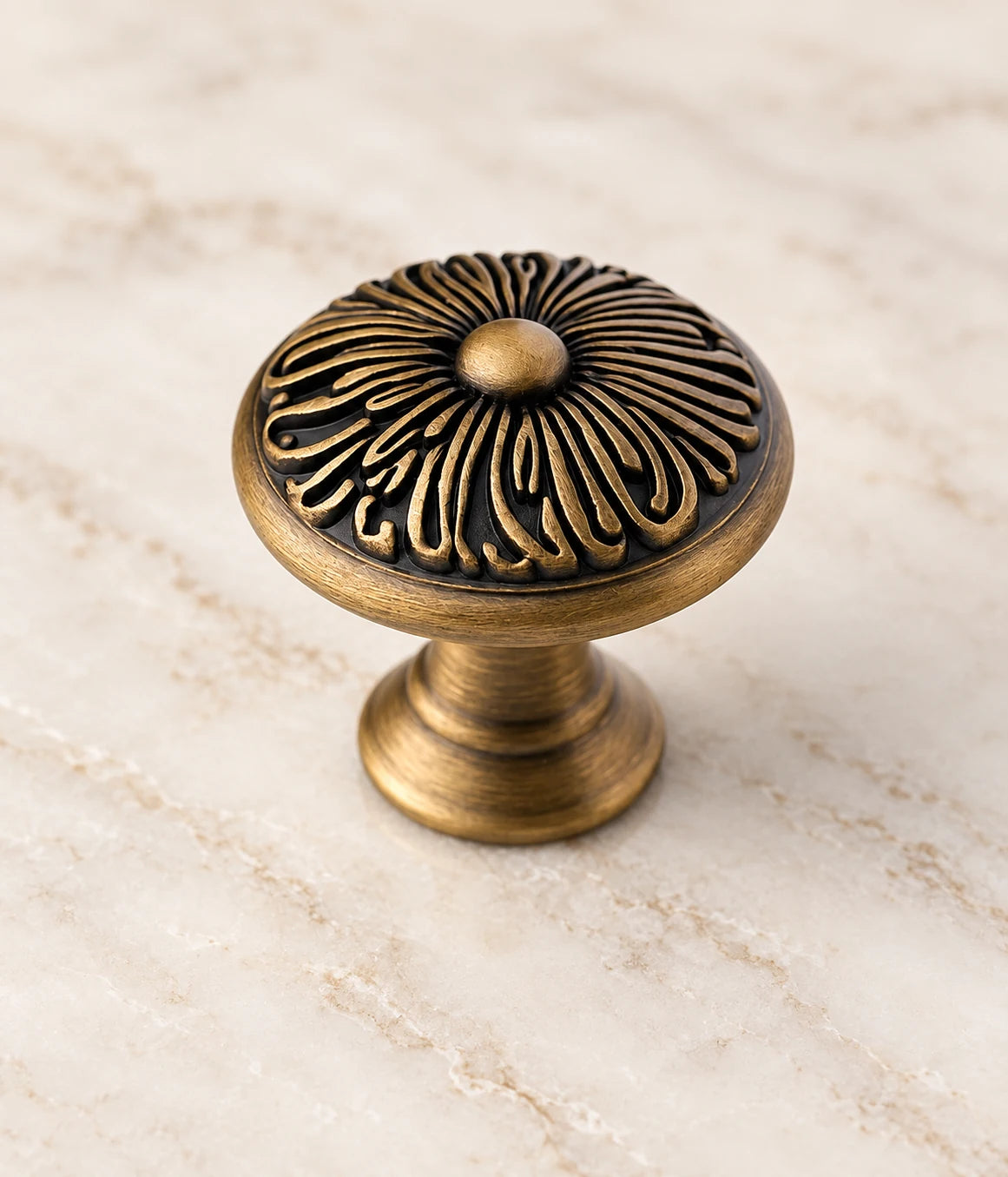 Close-up of raised curling petals and turned pedestal on a brass chrysanthemum knob
