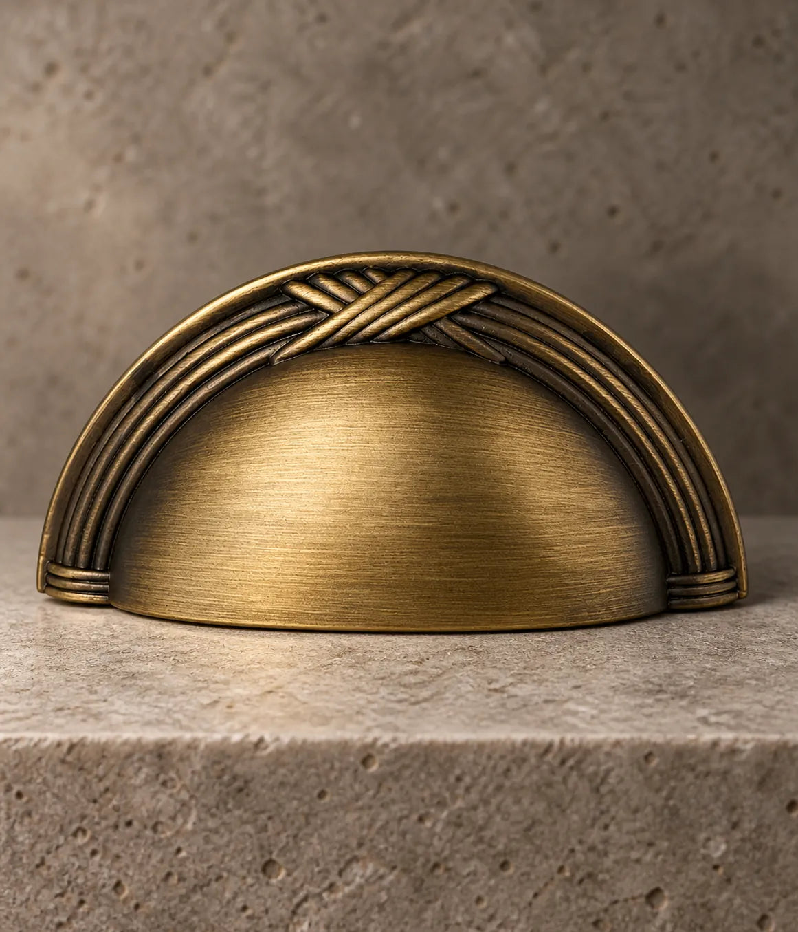 Close-up of the raised crossed-reed ornament and brushed brass cup grip