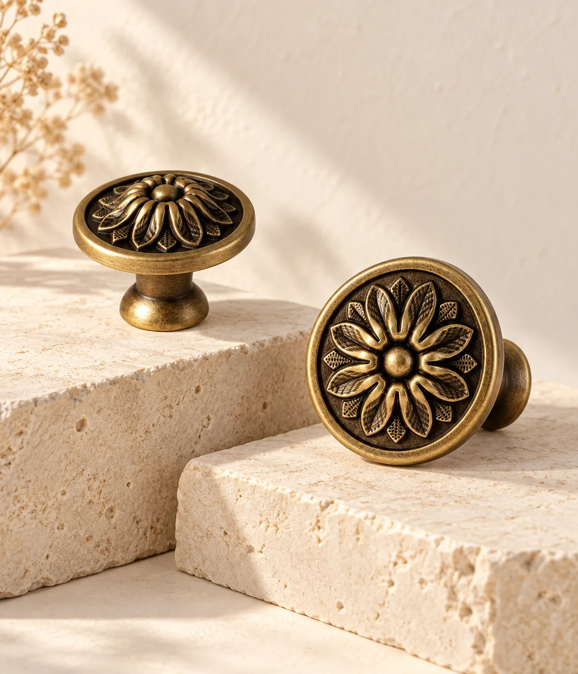 Antique brass floral disc cabinet knobs on ivory limestone showing both face sizes