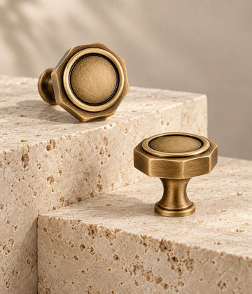 Antique brass octagonal cabinet knobs with circular insets on travertine steps