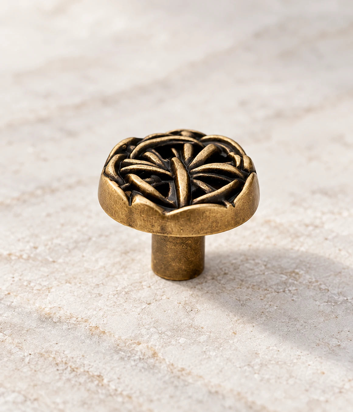 Close view of the scalloped rim and woven openwork on an antique brass knob