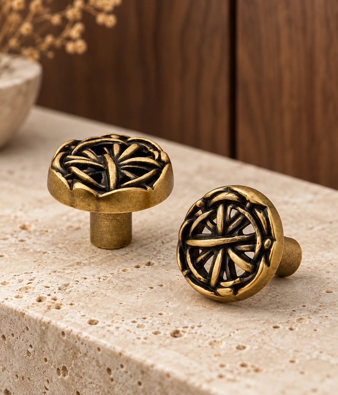 Antique brass openwork knobs styled on a stone console with walnut background