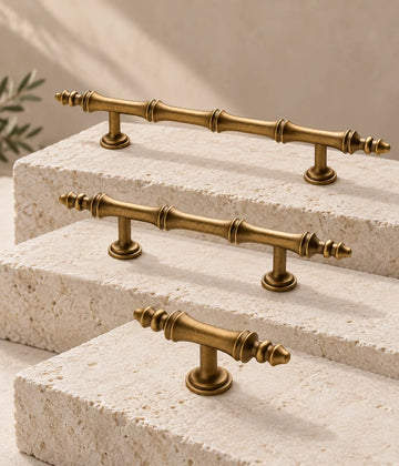 Antique brass segmented-finial cabinet pulls and matching T-knob on ivory limestone
