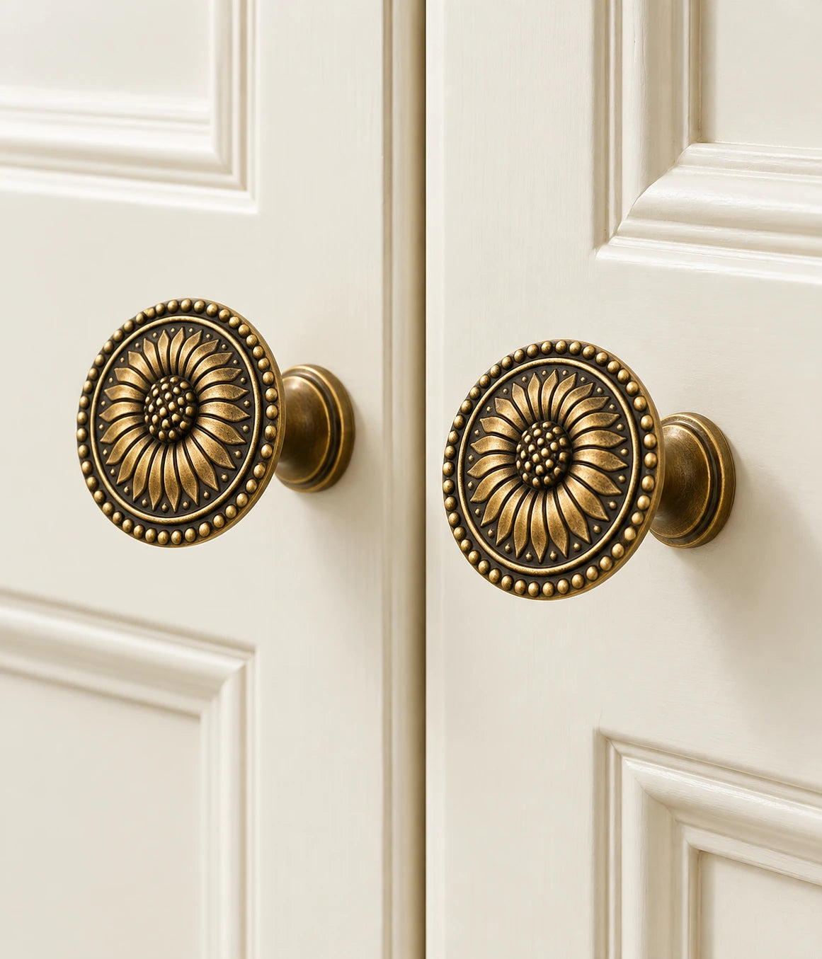 Antique brass sunflower knobs on cream cabinet doors