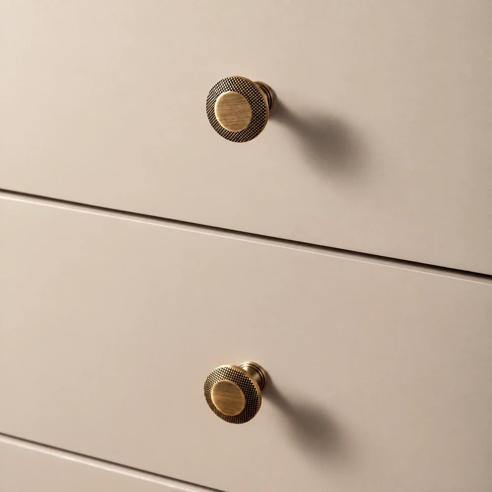 Antique brass knurled rim knobs on cream drawers