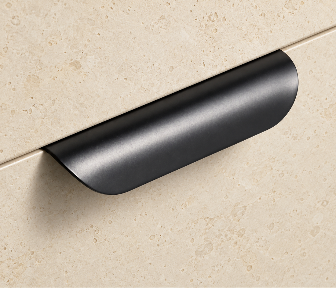 Brass Fold Edge Pull Handle displayed on pale limestone.
