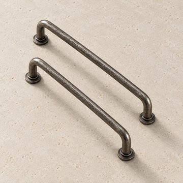 Antique Silver Brass Handle displayed on pale limestone.