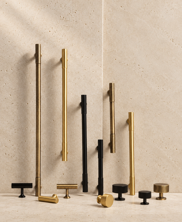 Solid Brass Art Deco Handle displayed on pale limestone.
