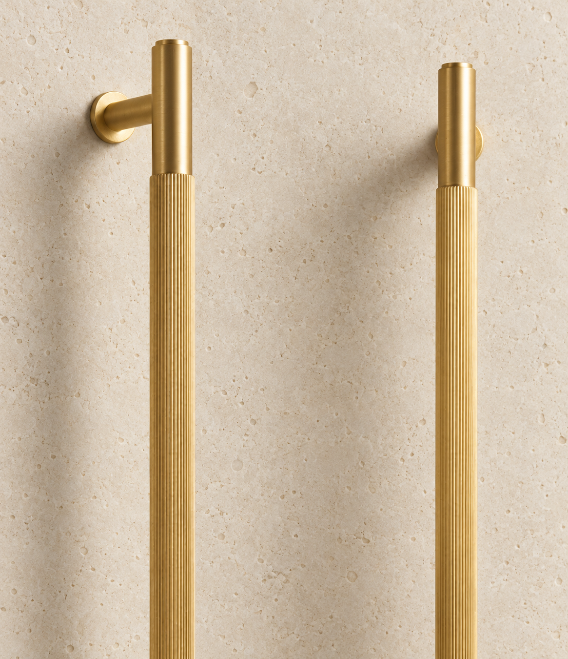 Solid Gold Brass Linear Handle displayed on pale limestone.