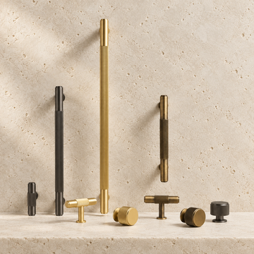 Solid Brass Linear Handle & Knob Set displayed on pale limestone.